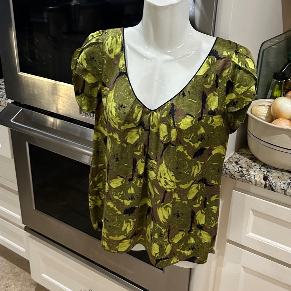 Kenar 100% silk fabric top fabric color is a blend of greens with black accents.